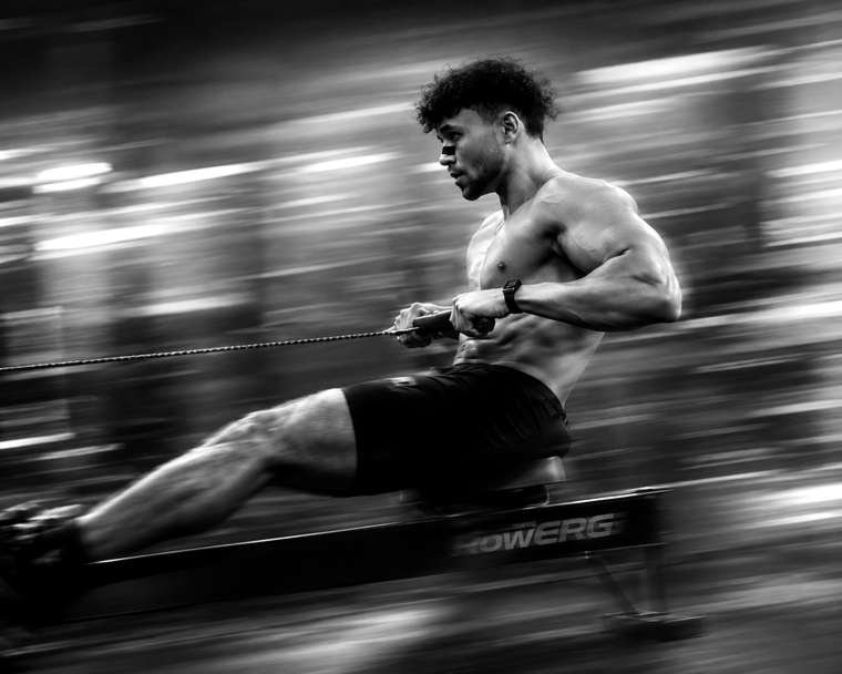 Athlete pulling hard on a rowing machine