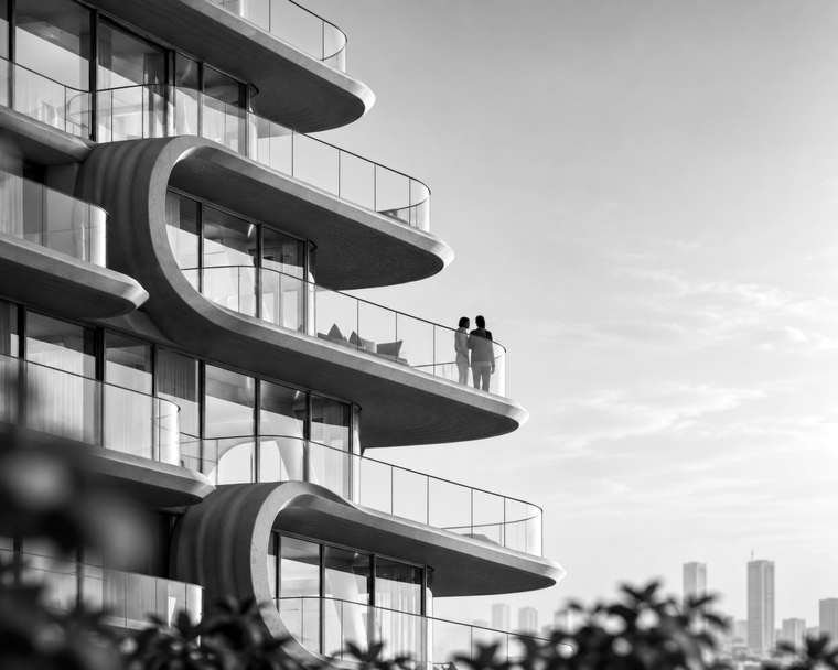 Curved white residential tower with people on its balconies